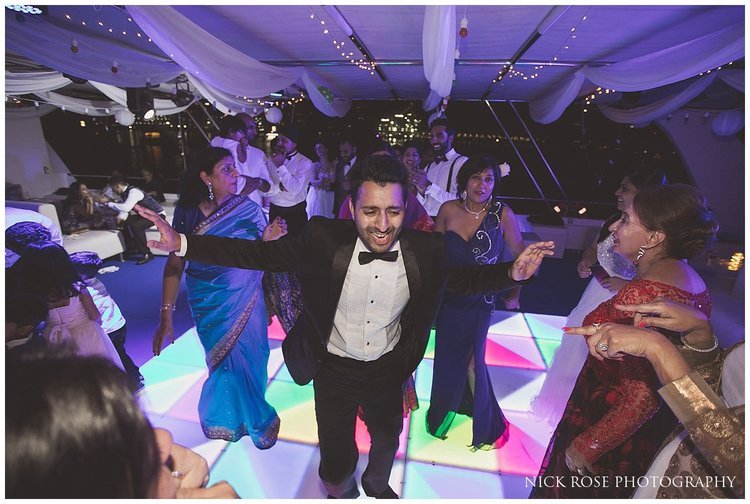  Guest in tuxedo dancing at a Dubai destination wedding 
