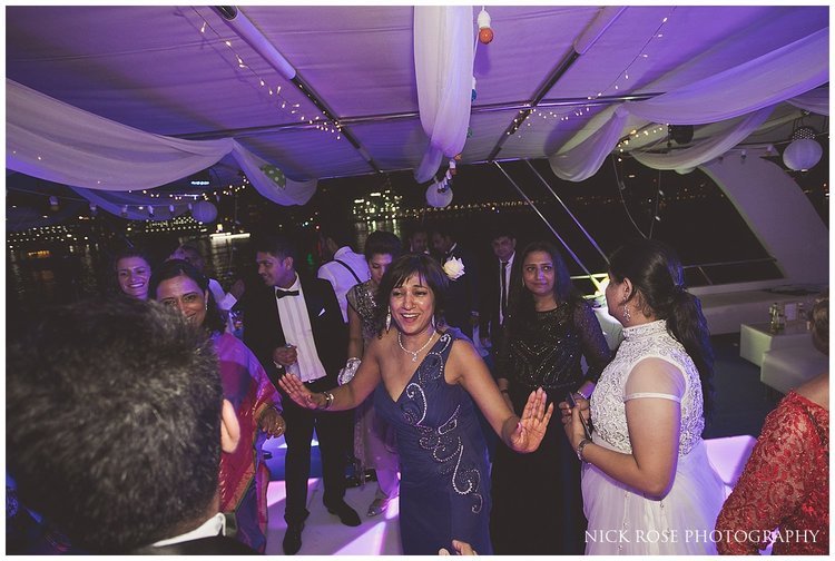  Guests dancing during an Indian wedding reception in Dubai 