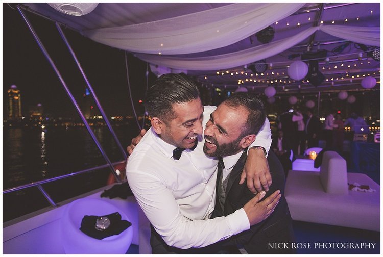  Friends hugging on the dance floor during a Dubai wedding reception 