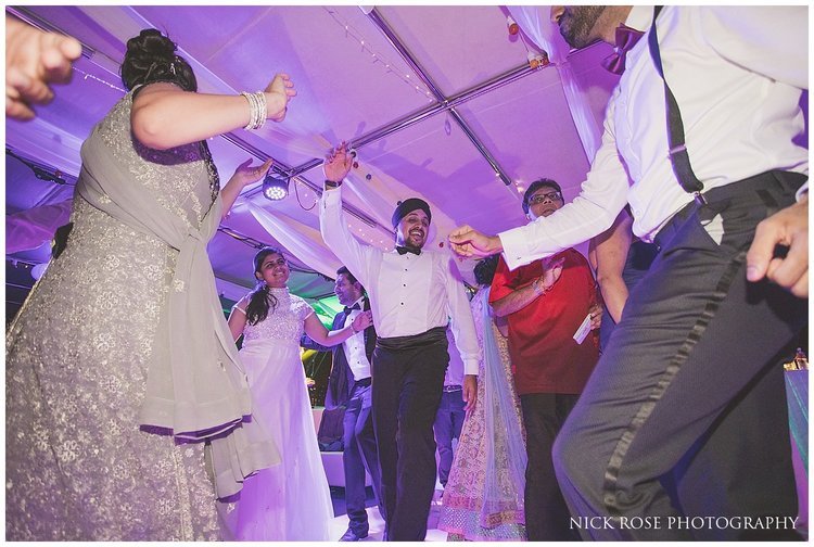  Guests having fun on the dance floor at a Hindu wedding reception at the Dubai Marina Yacht Club 