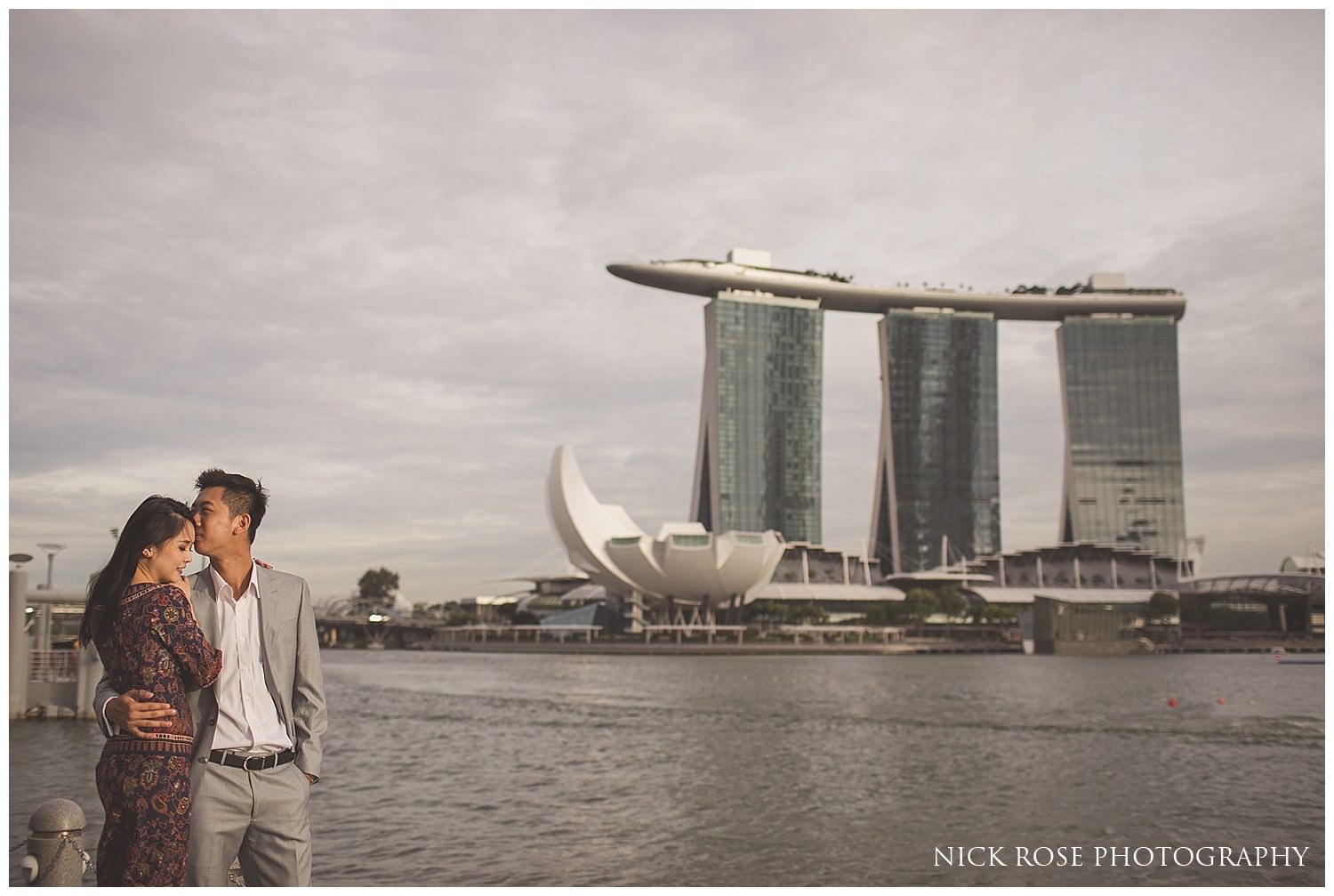 Couple embracing in front of the Marina Bay Sands Hotel for a Singapore pre wedding photography shoot 