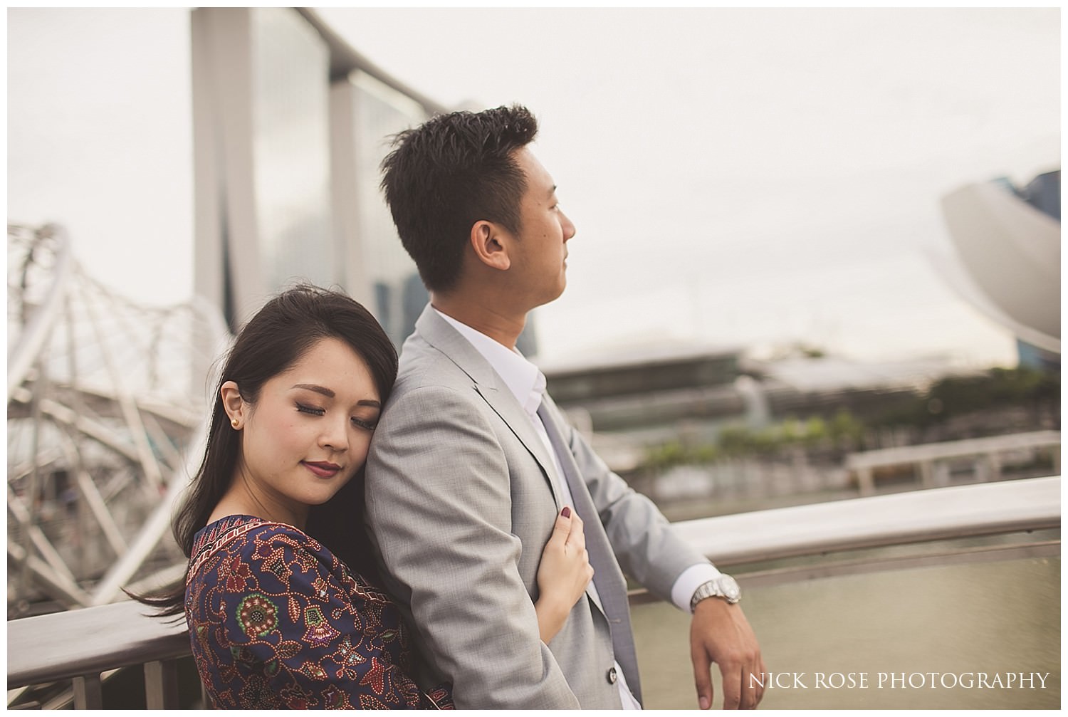  Woman holding her fiance during a romantic pre wedding photography shoot at Marina Bay in Singapore 