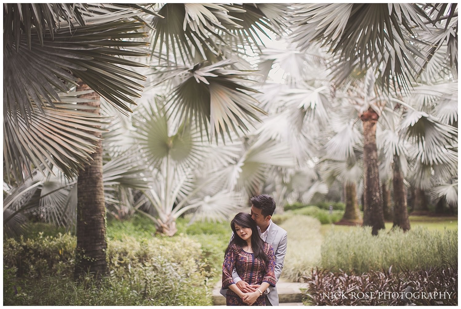  Pre wedding couple under palm trees at a Gardens by the Bay pre wedding photo shoot in Singapore 