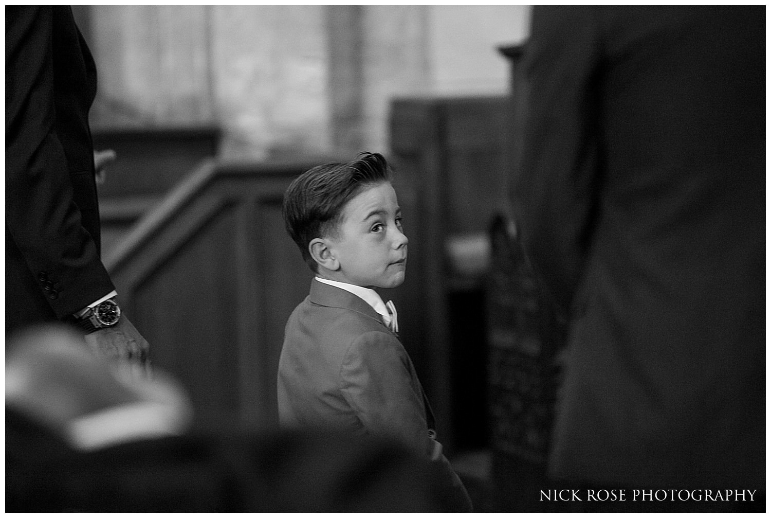  Boy looking at bride and groom during a Yorkshire wedding service at St Mary's in Tickhill 