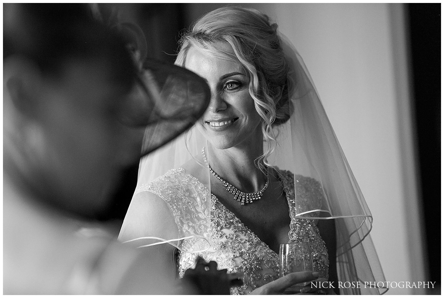  Bride standing next to natural window light at a Rudding Park wedding 