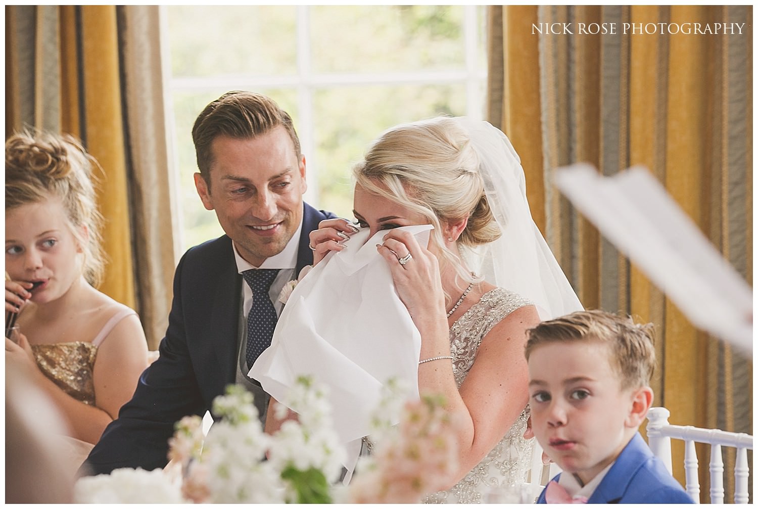  Bride wipes away a tear during the wedding speeches in the Rudding Park Hotel 