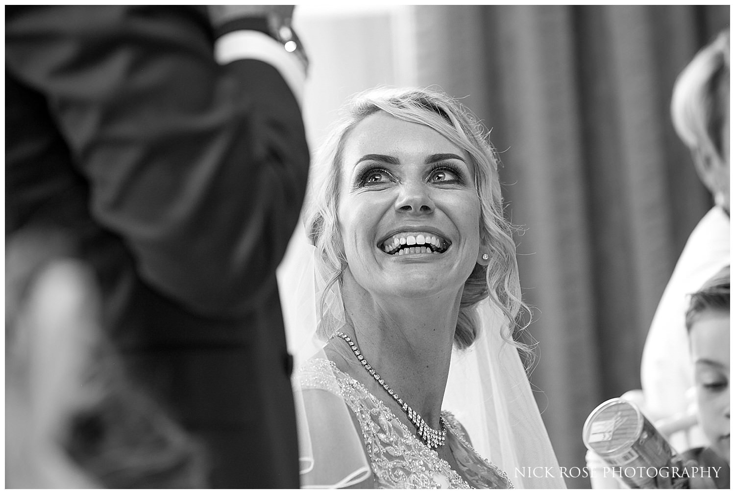  Bride smiling and listening to the Rudding Park Hotel wedding reception speeches 