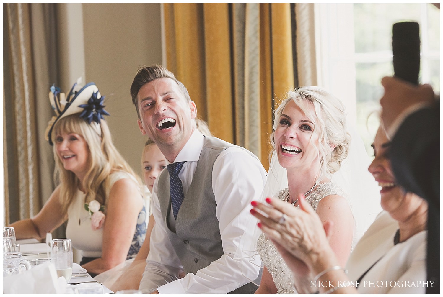  Groom and his bride laughing during the wedding speeches at the Rudding Park Hotel 