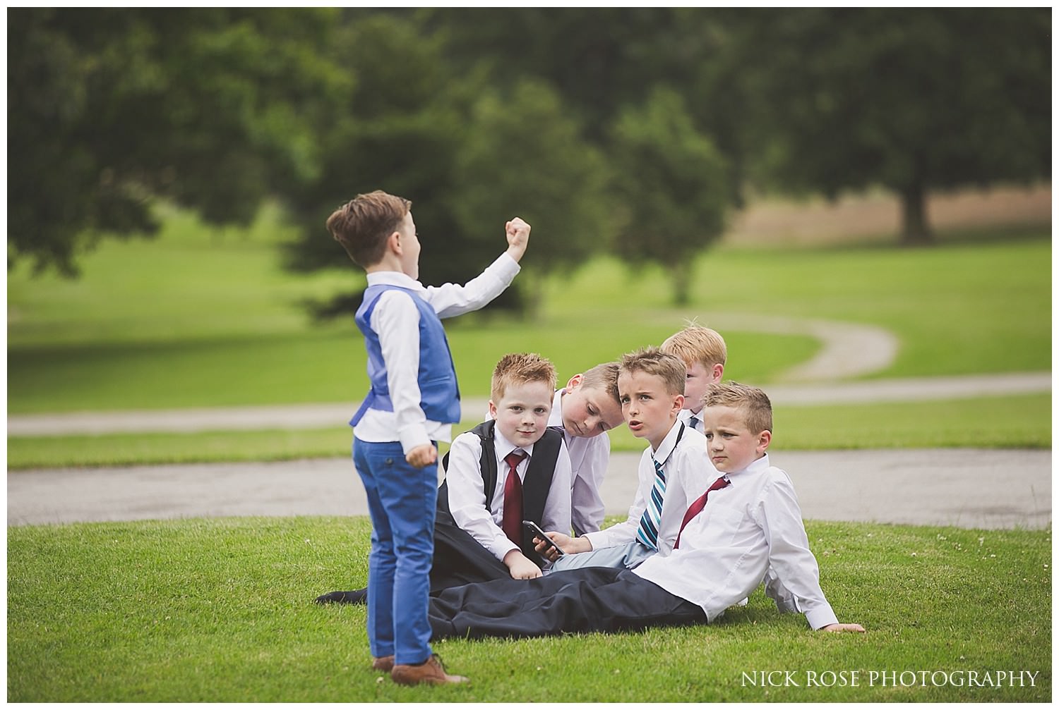  Young boys sitting outside on the grass during a Rudding Park Hotel wedding in Harrogate 