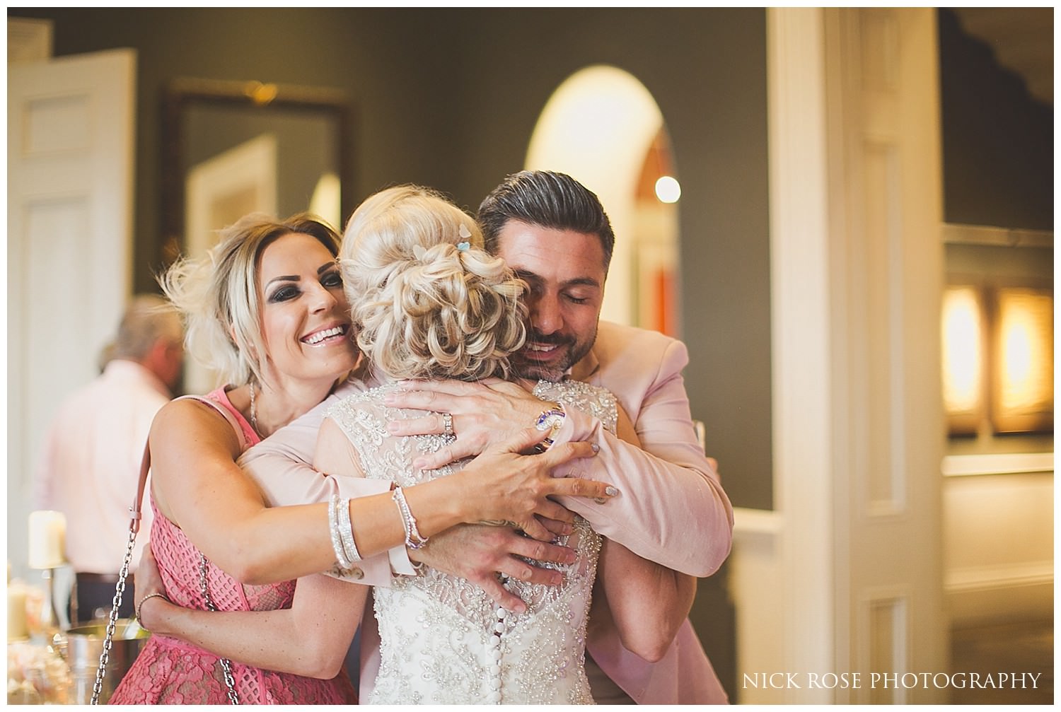  Guests hugging bride at a Rudding Park Hotel wedding reception in Harrogate 
