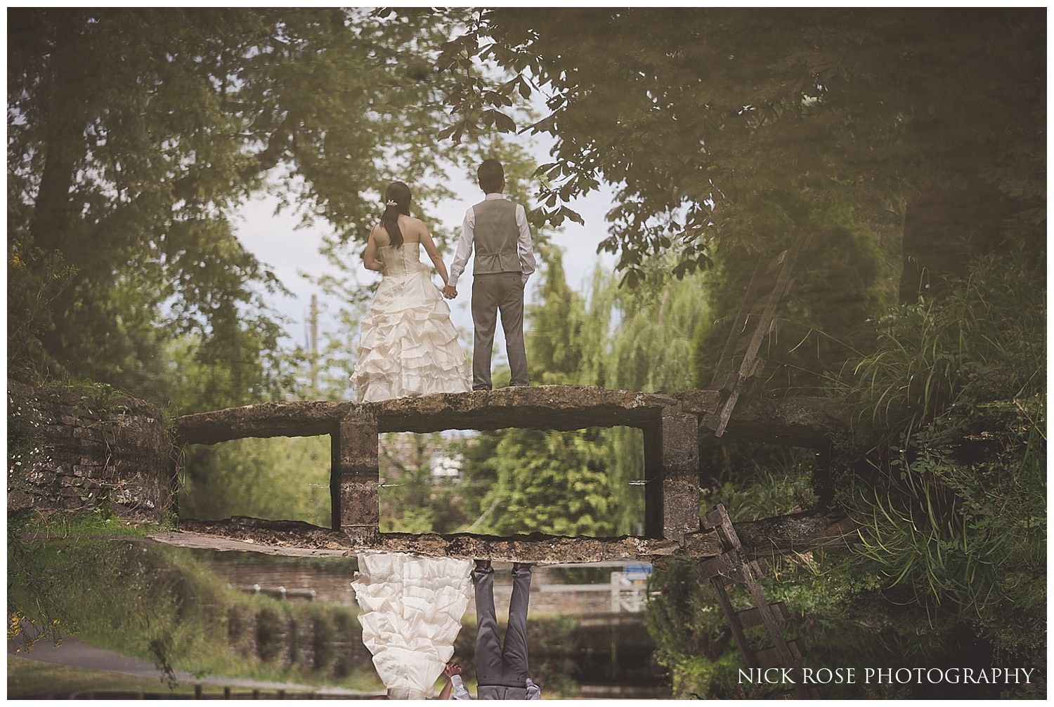  Reflection of a bride and groom in a stream during a pre wedding photography session in Lower Slaughter in the Cotswolds countryside UK 