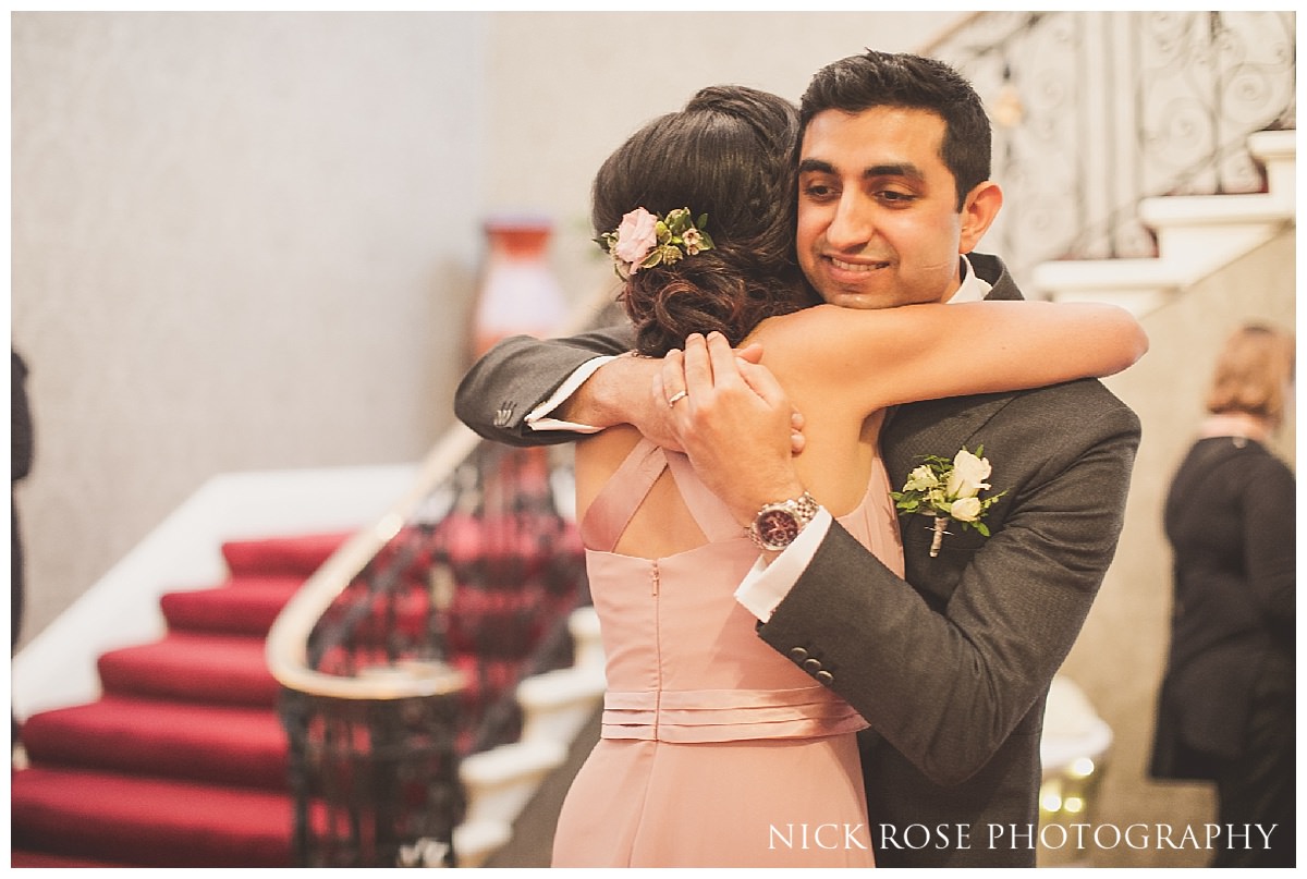  Groom hugging a bridesmaid after a Hedsor House wedding 