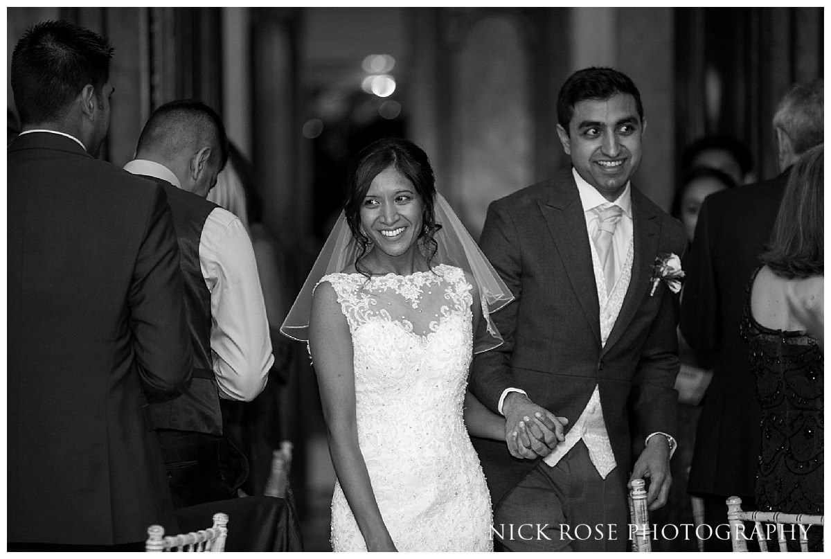  Bride and groom holding hands and entering the wedding reception at Hedsor House wedding in Buckinghamshire 