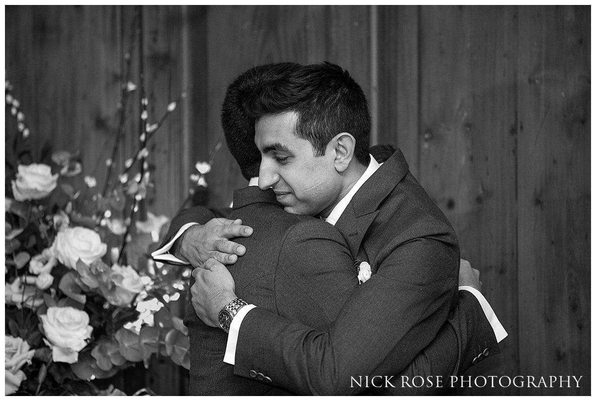  Groom and best man hugging at a Hedsor House wedding in Buckinghamshire 