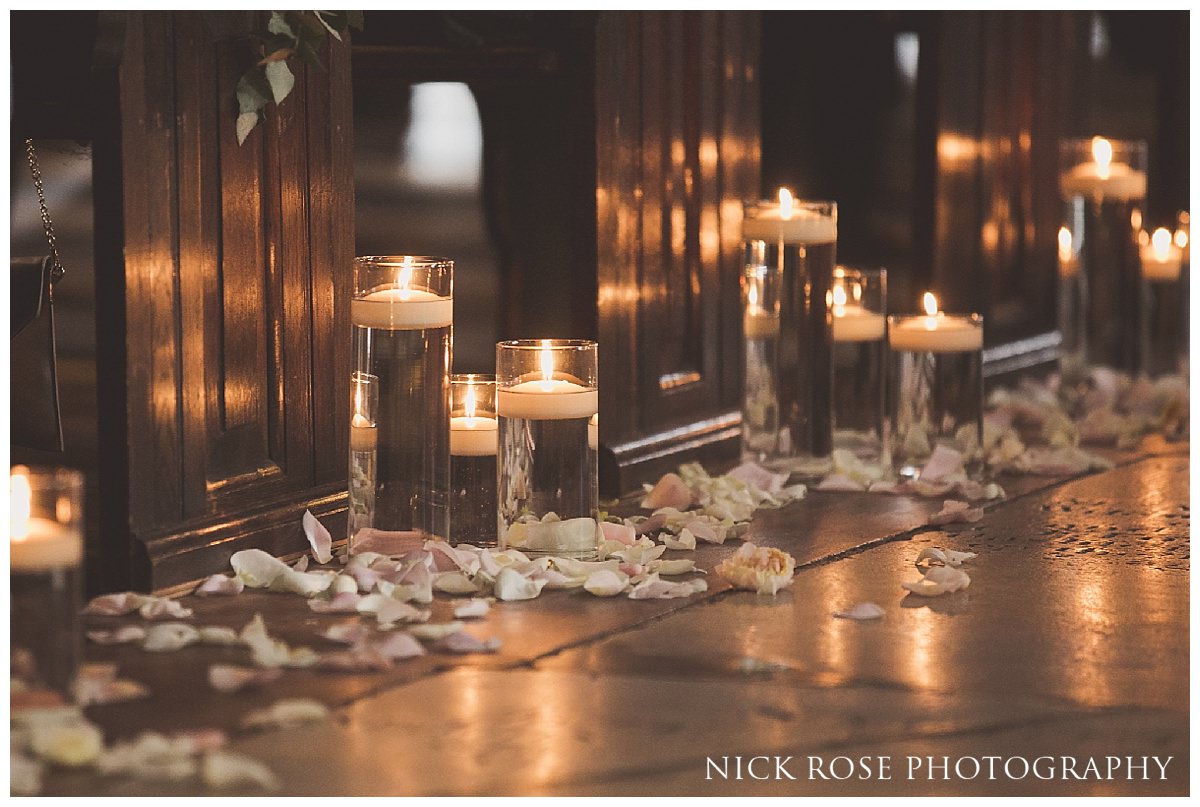  Candles along the church isle for a St Dunstan's church wedding in Stepney 