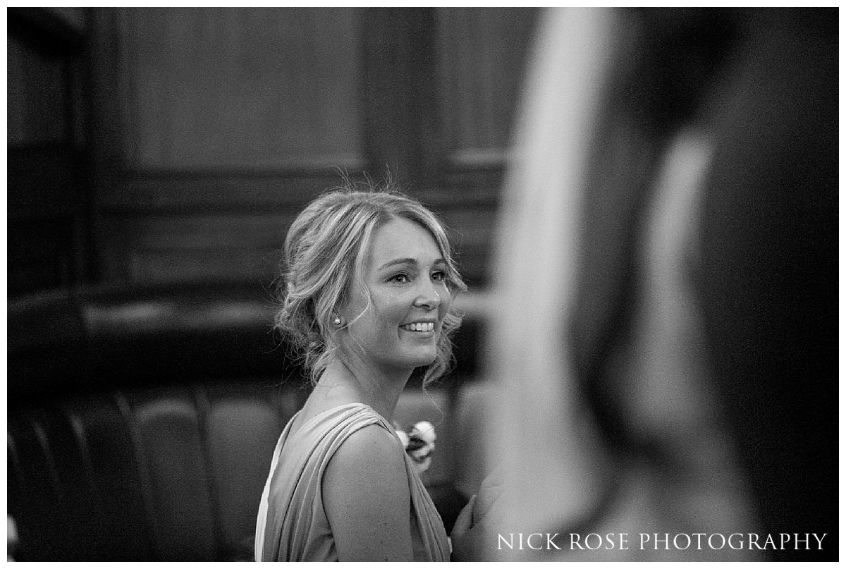  Bridesmaid watching ceremony during a Hawksmoor Guildhall wedding ceremony in London 
