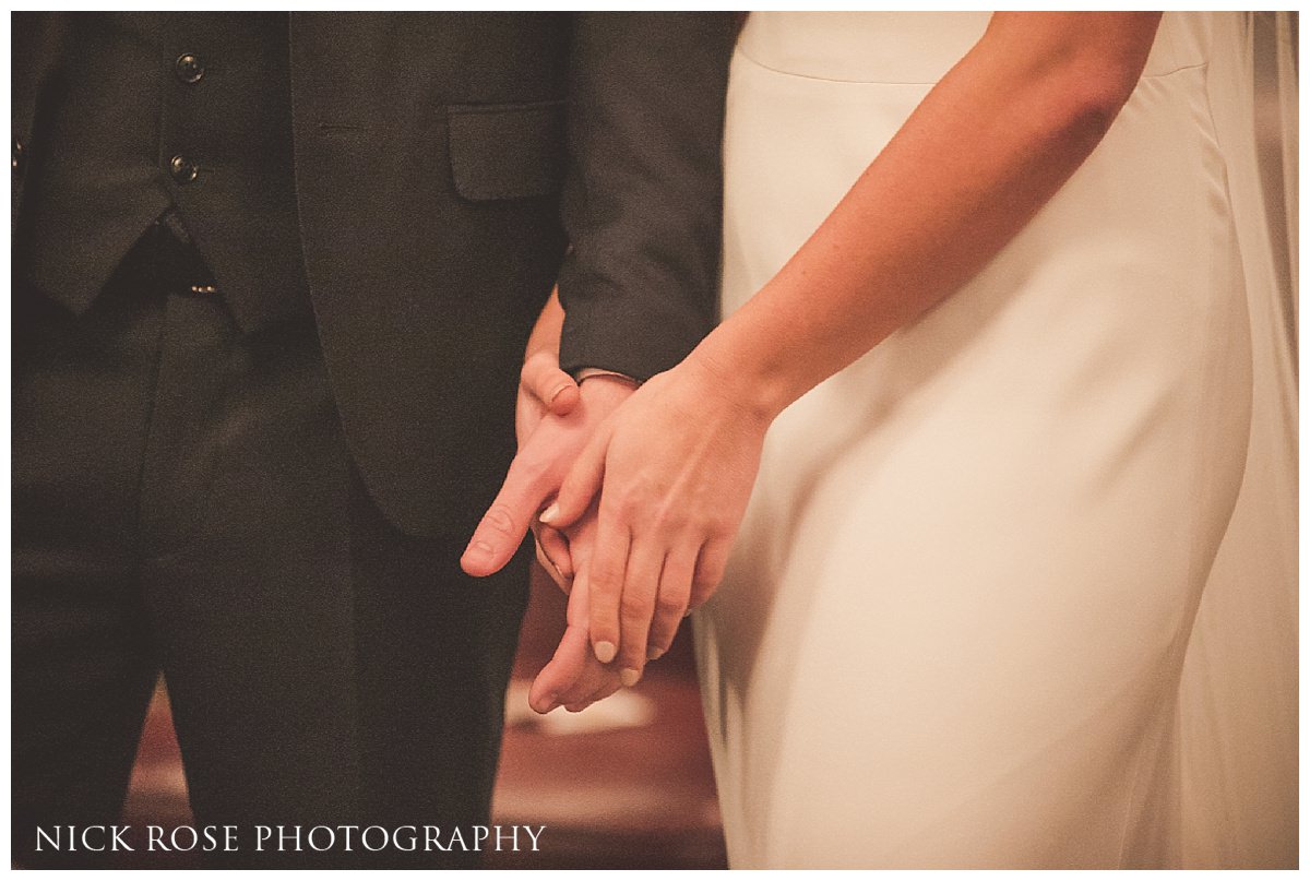  Bride and groom holding hands during a Hawksmoor Guildhall wedding ceremony in London 