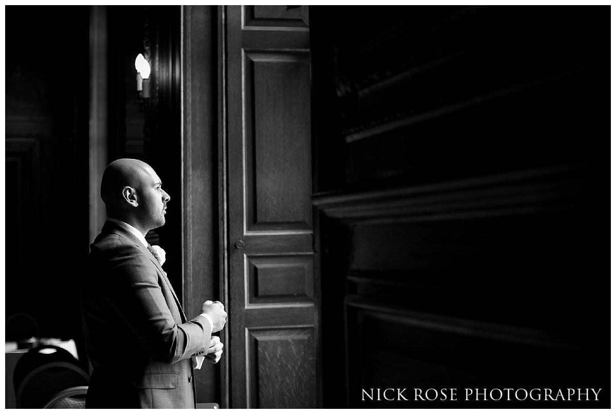  Groom standing by the window before a civil wedding ceremony at Moor Park Rickmansworth&nbsp; 