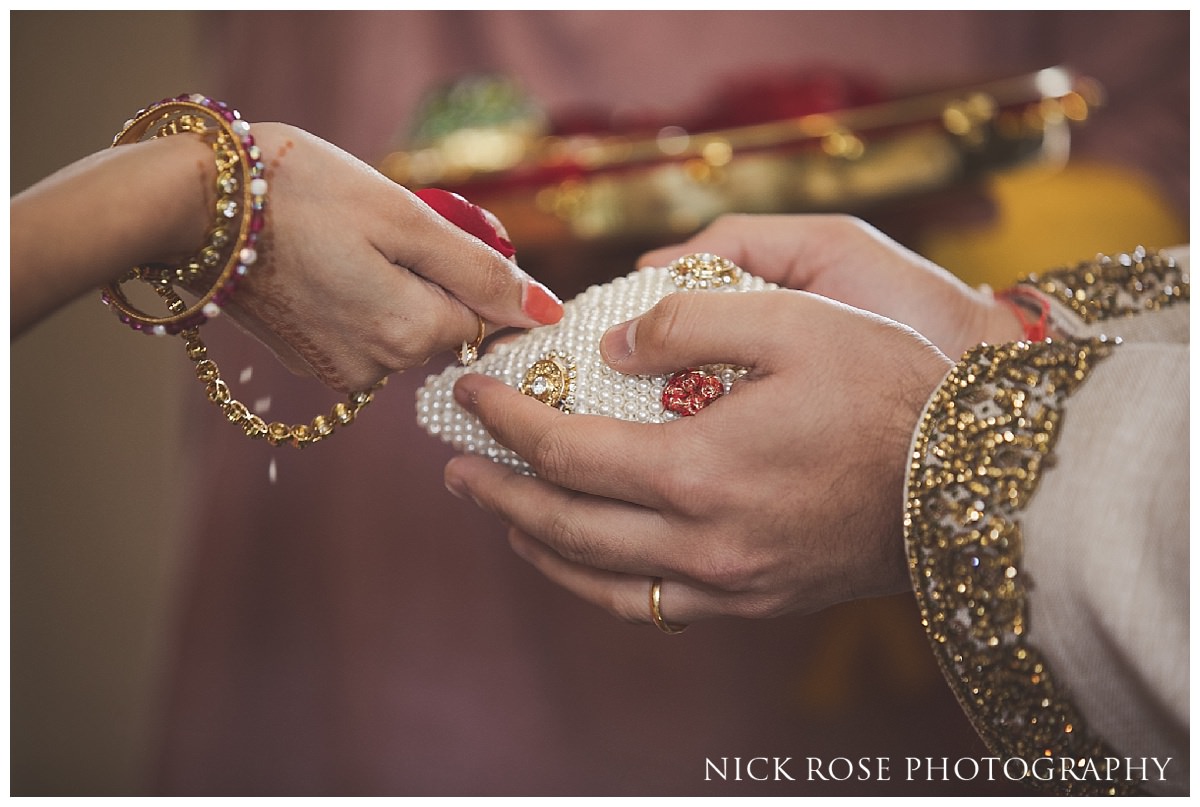  Groom holding a jewel encrusted coconut before a Hindu wedding ceremony at the Grove 
