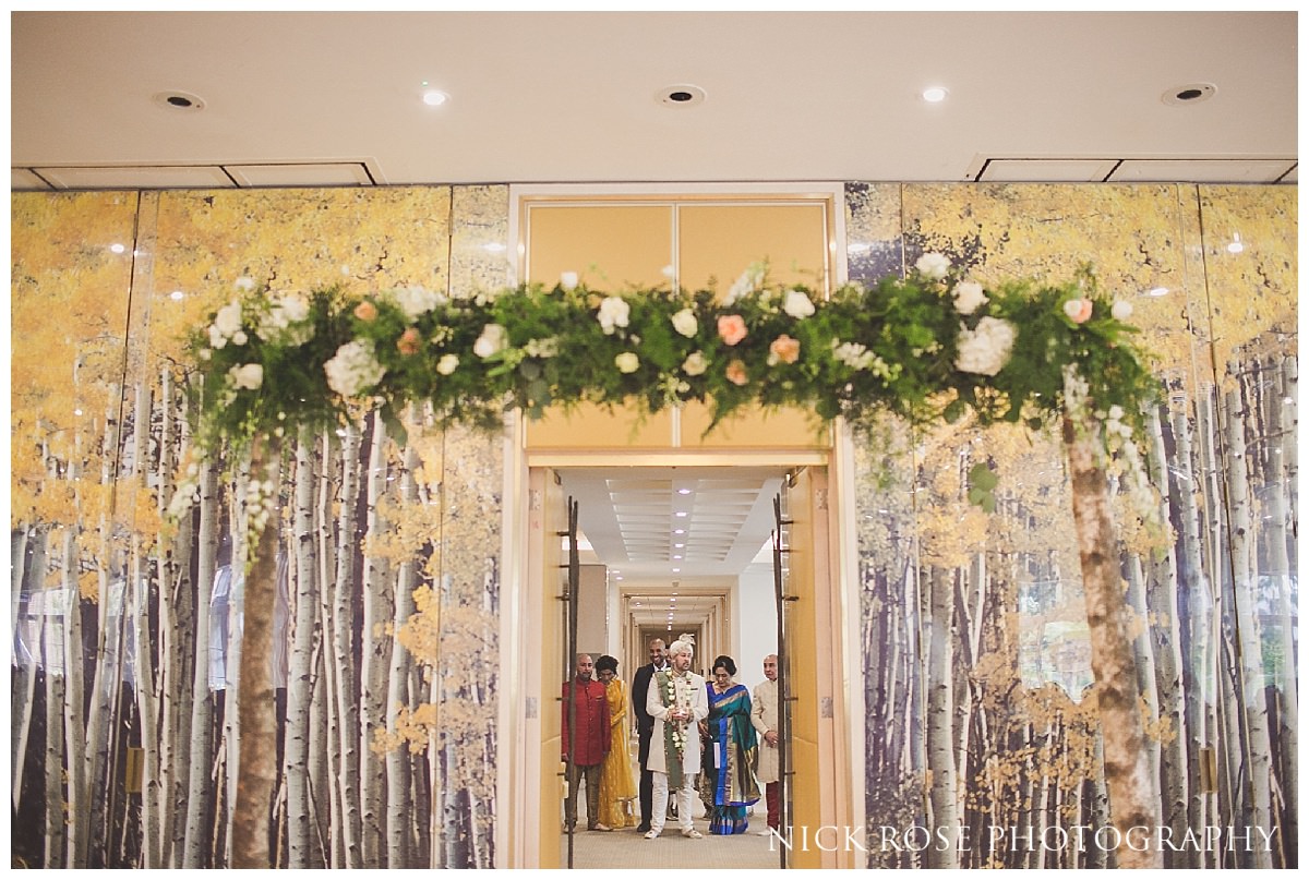 Hindu wedding ceremony entrance by the groom and his family in the Amber room at the Grove hotel