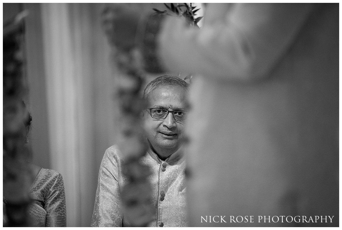  Brides father looking on during an Indian wedding 