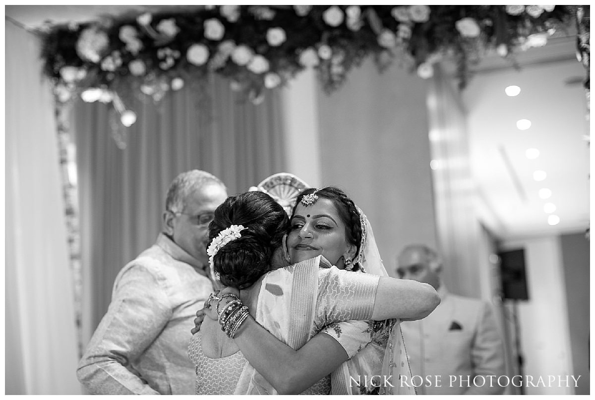  Bide hugging a family member after her Indian wedding 