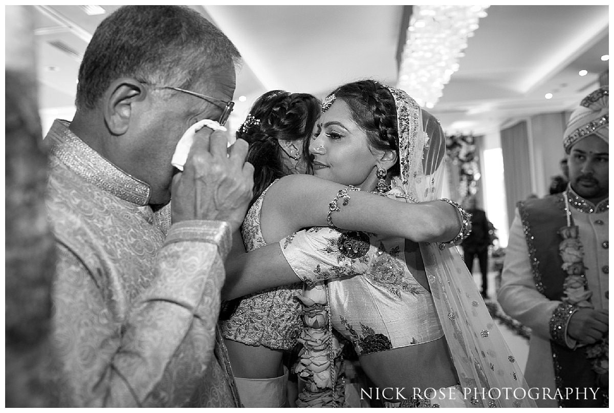  Father shedding a tear during an emotional Vidaai following a Hindu wedding ceremony at The Grove in Hertfordshire 