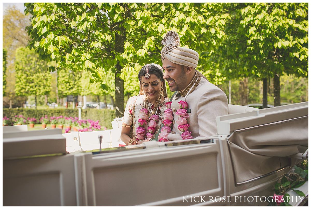 Bride and groom exiting a Hindu wedding at The Grove on a horse and carriage