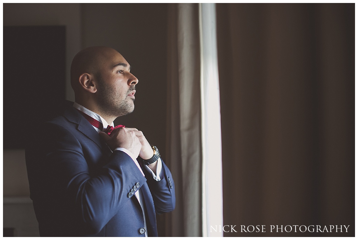  Indian groom getting ready for a Hindu reception at The Grove in Hertfordshire 