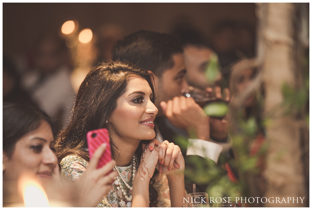  Guest smiling during the wedding speeches at The Grove in Watford 