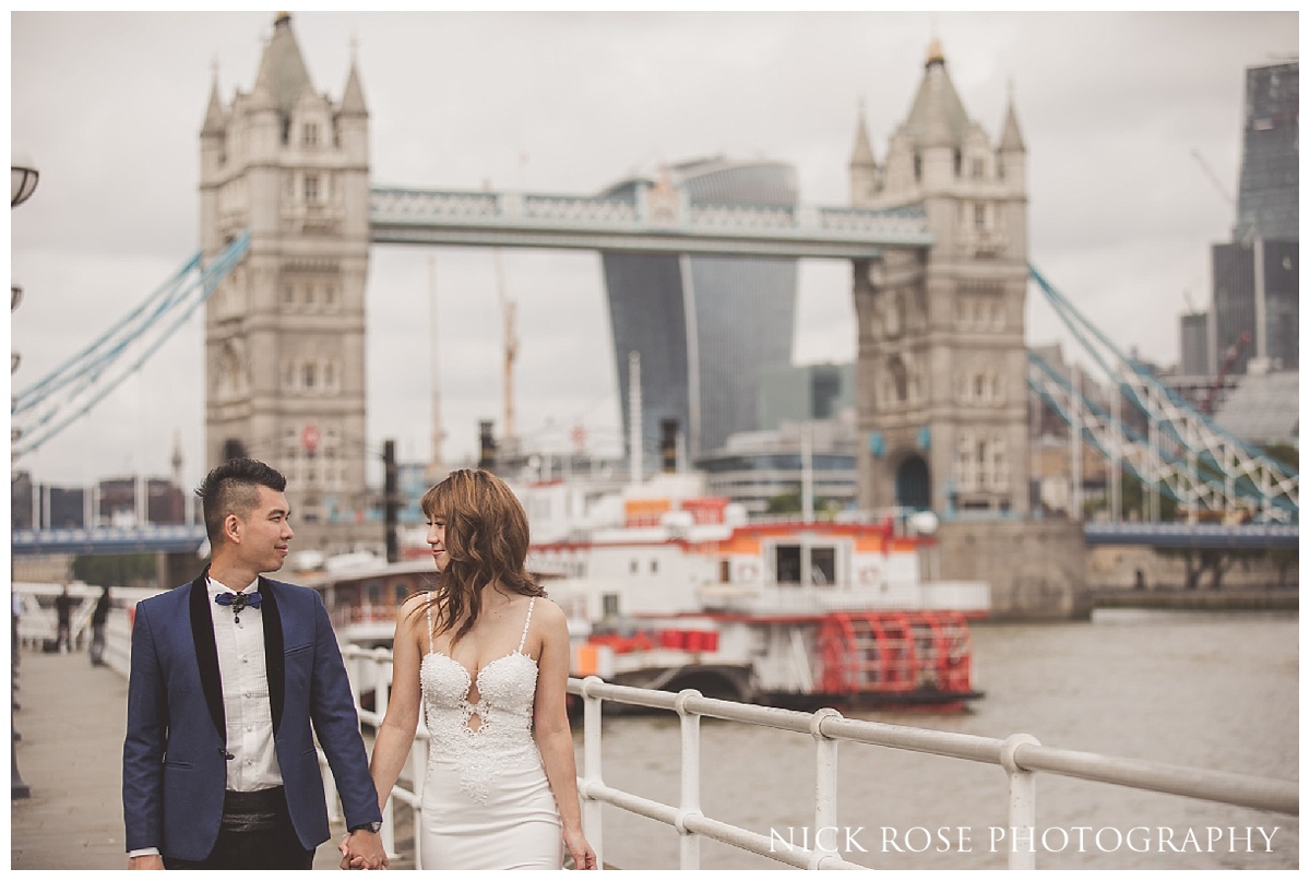  Bride and groom in front of Tower Bridge during a London pre wedding photography shoot 