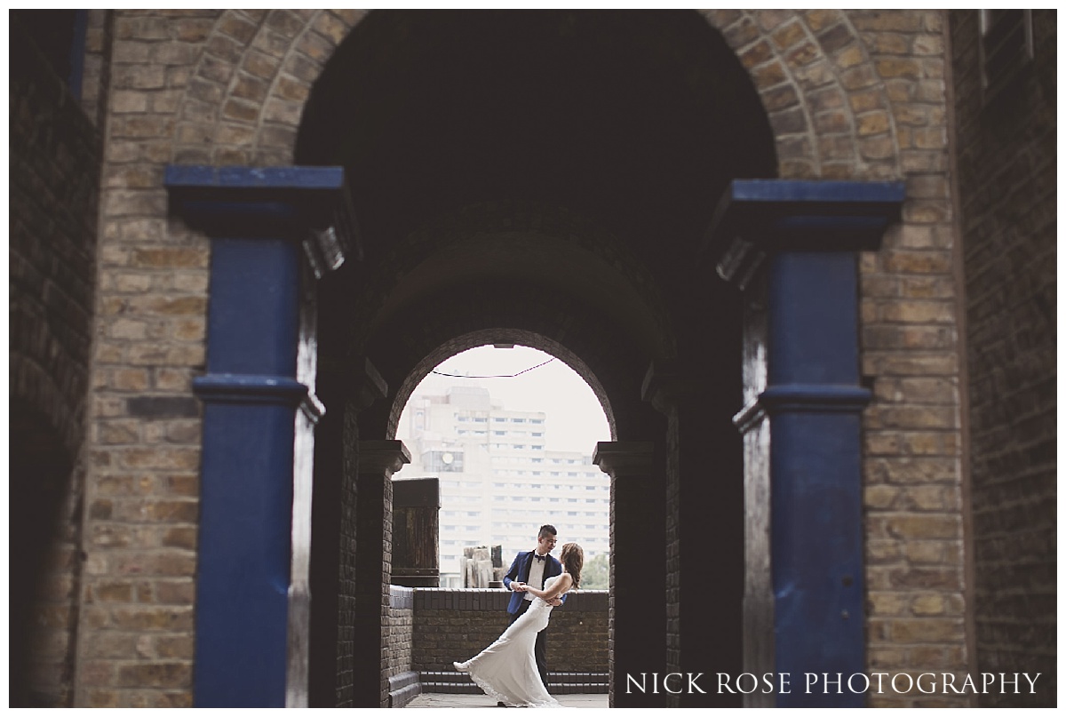 Groom dancing with bride for a pre wedding shoot along the River Thames in London