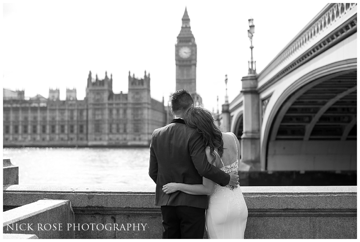  Couple looking across the River Thames at Big Ben during a pre wedding photography shoot in London 