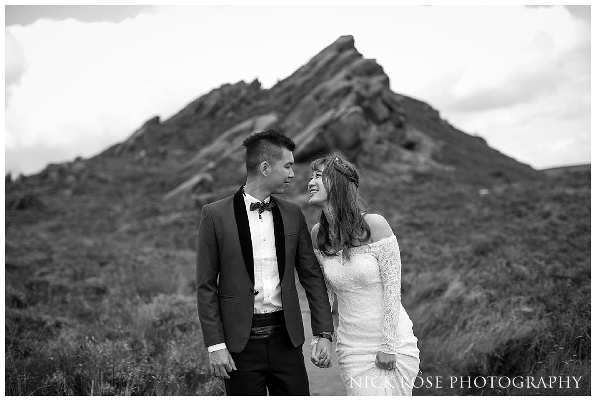 Pre wedding couple holding hands for a photograph at Ramshaw Rocks in the Peak District, Derbyshire