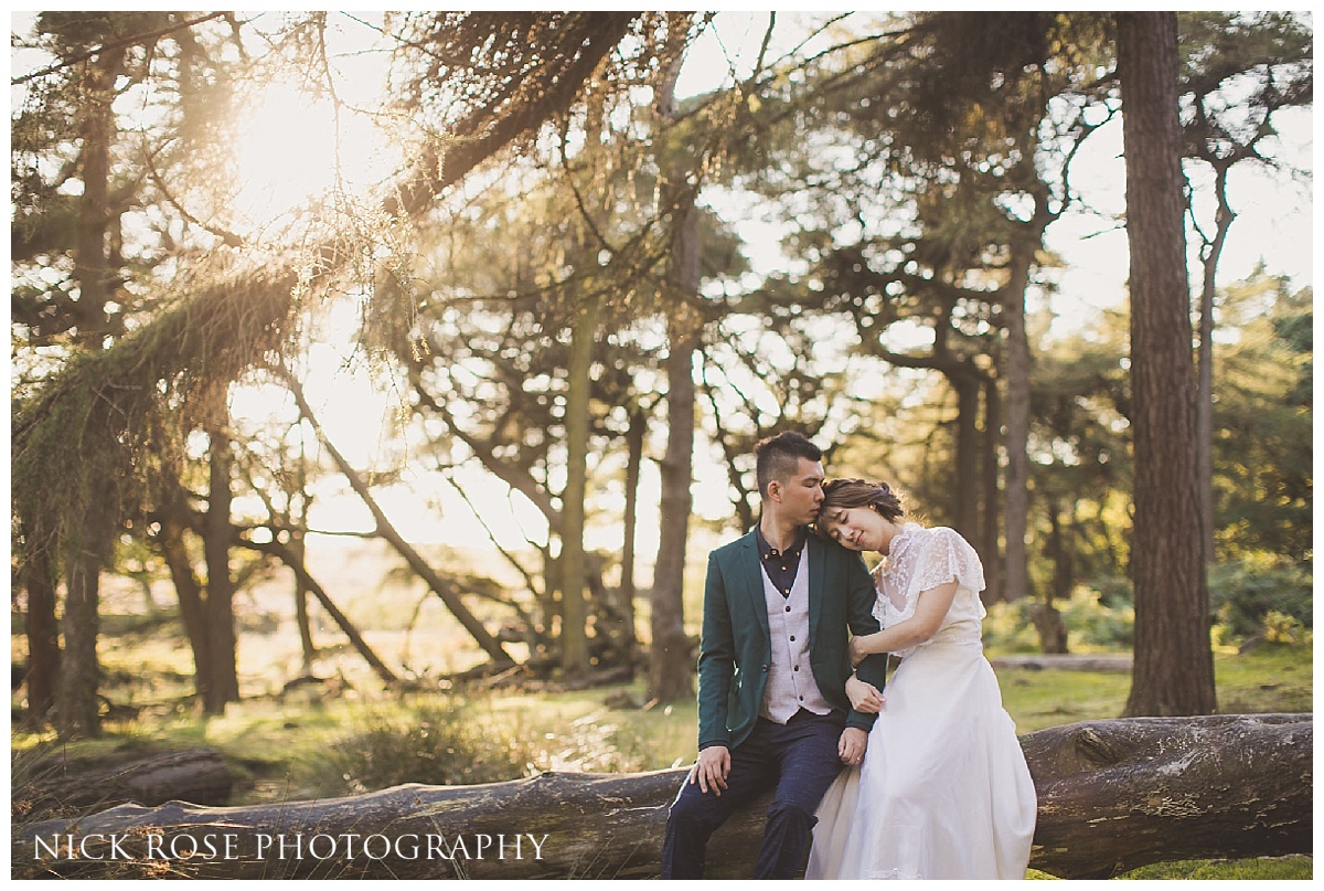 Pre wedding photography couple sitting on a fallen tree at sunset at the Roaches in the Peak District 