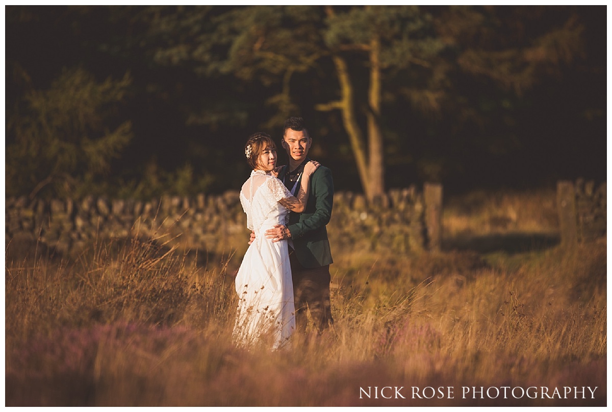  Couple from Hong Kong embracing during a sunset pre wedding photography shoot in the Peak District 