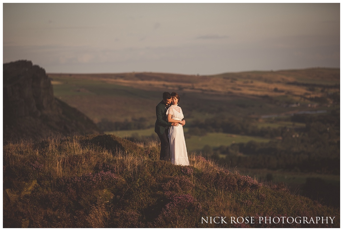  Groom with his arms around bride during a sunset pre wedding engagement photography shoot in the Peak District 
