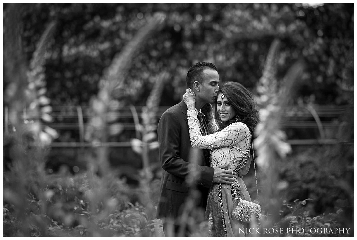  Asian bride and groom embracing in Hyde Park in London for a pre wedding photography portrait 