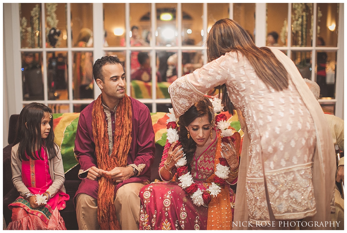  Garlands being placed around bride and groom during a Pakistani wedding mehndi at the Sheraton Grand in Park Lane 