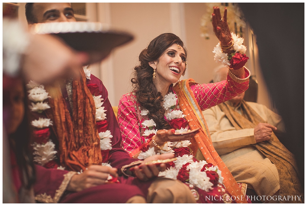  Garlands being placed around bride and groom during a Pakistani wedding mehndi at the Sheraton Grand in Park Lane 