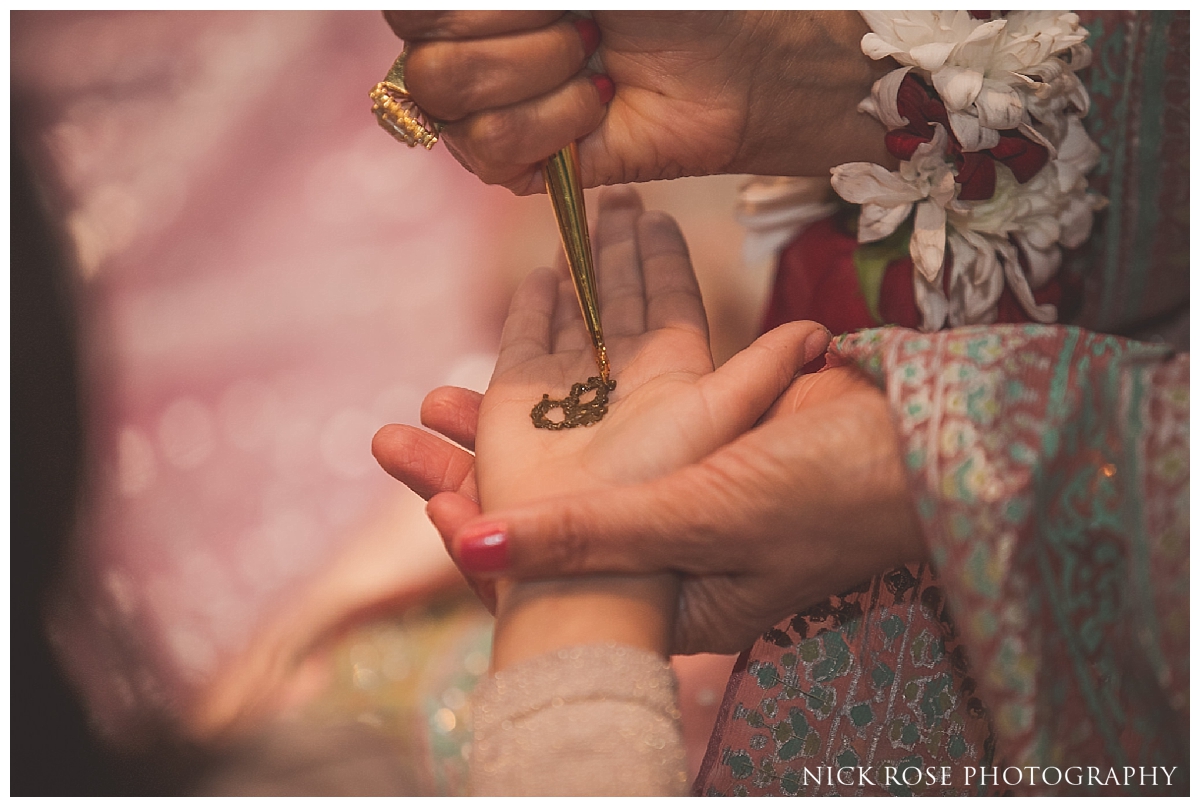  Henna being put on guests hands during a Pakistani wedding event at the Sheraton Grand in Park Lane 