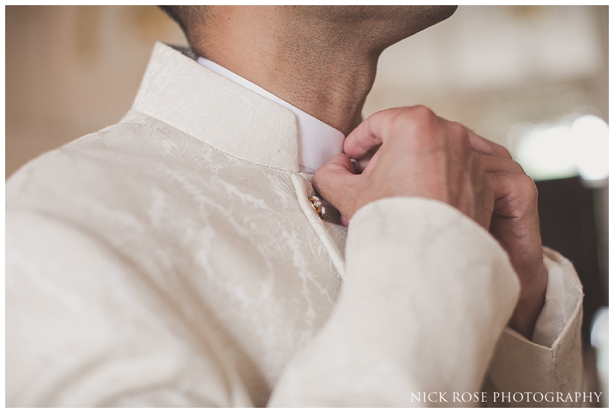  Groom putting on his jacket before a Pakistani Wedding at the Ritz Hotel London 
