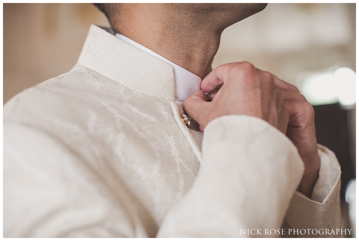 Groom putting on his jacket before a Pakistani Wedding at the Ritz Hotel London