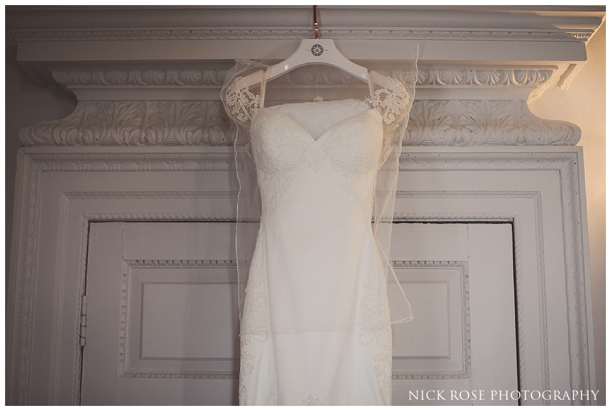  Wedding dress hanging up before a Buxted Park hotel wedding in East Sussex 