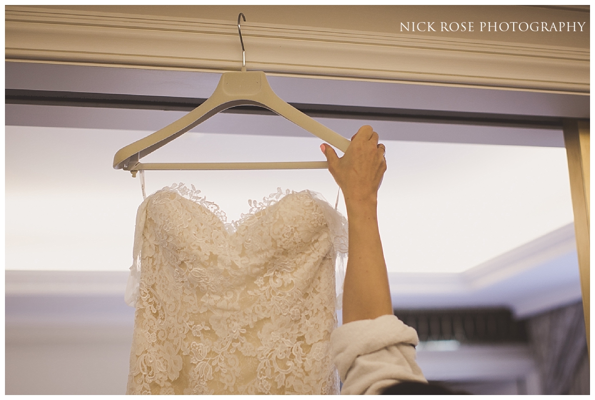 Bride reaching for her dress before a Mayfair wedding in London