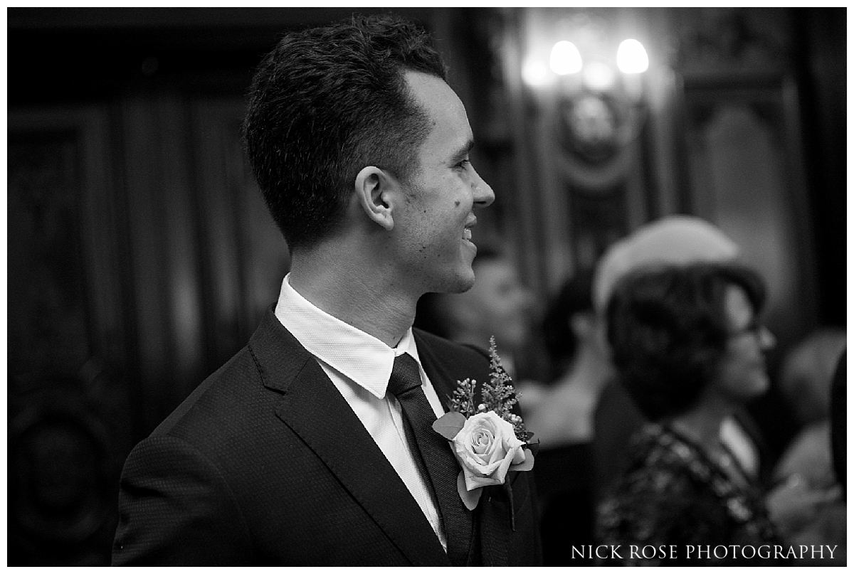  Groom watching bride walk down the Isle for a Mayfair Wedding at Dartmouth House in London 
