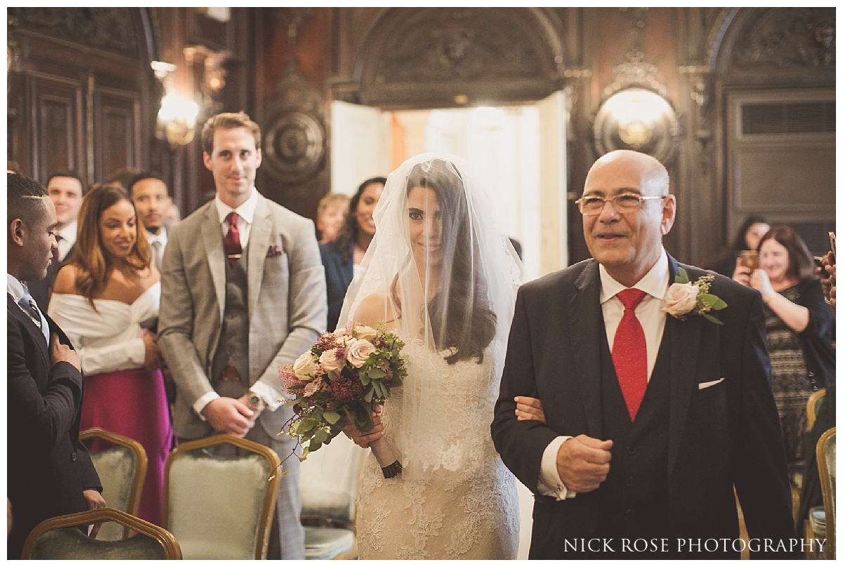 father walking daughter down the Isle for a Mayfair Wedding at Dartmouth House in London