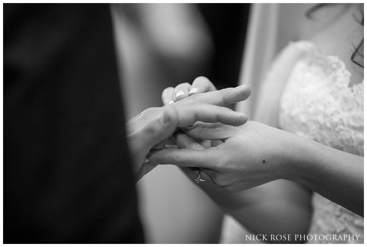  Couple holding hands during a wedding ceremony at Dartmouth House in London's Mayfair 