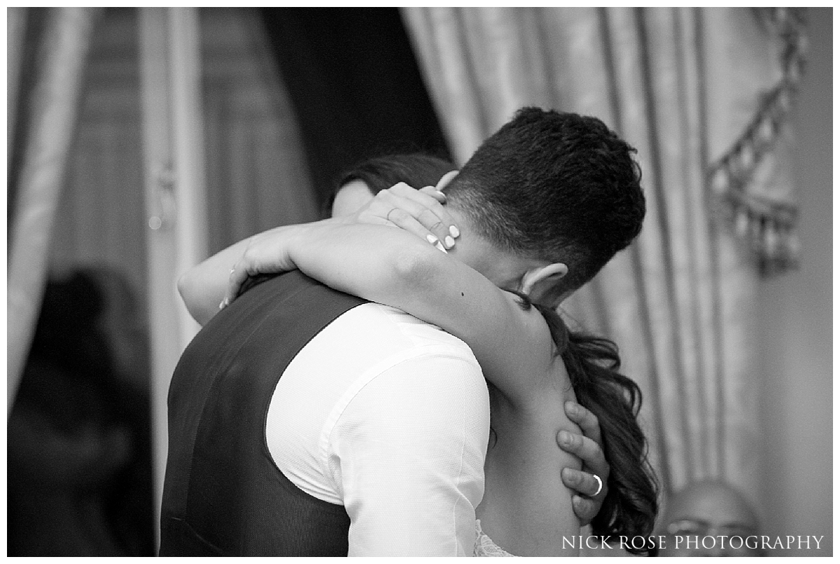  Bride and groom embracing during a Mayfair wedding reception in London 