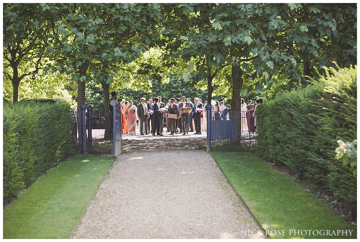  Guests arriving for an outdoor wedding reception at The Dairy in Waddesdon Manor Buckinghamshire 